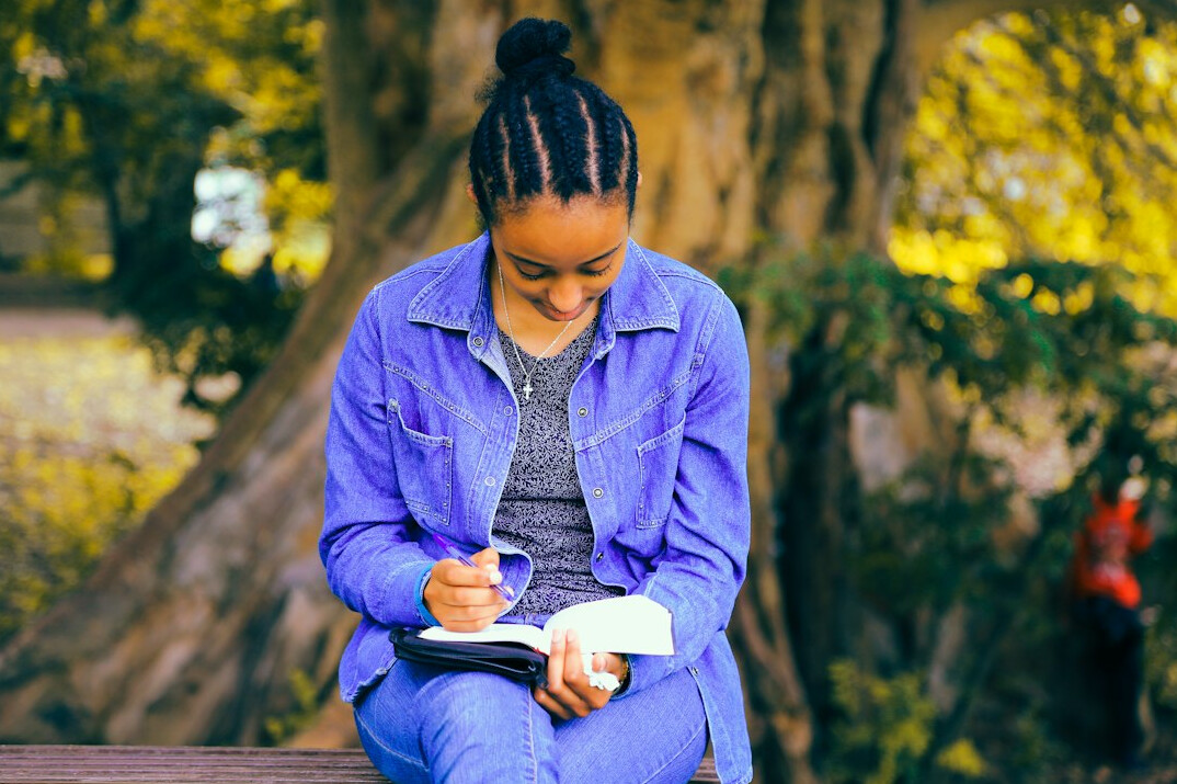 woman writing notes thoughtfully